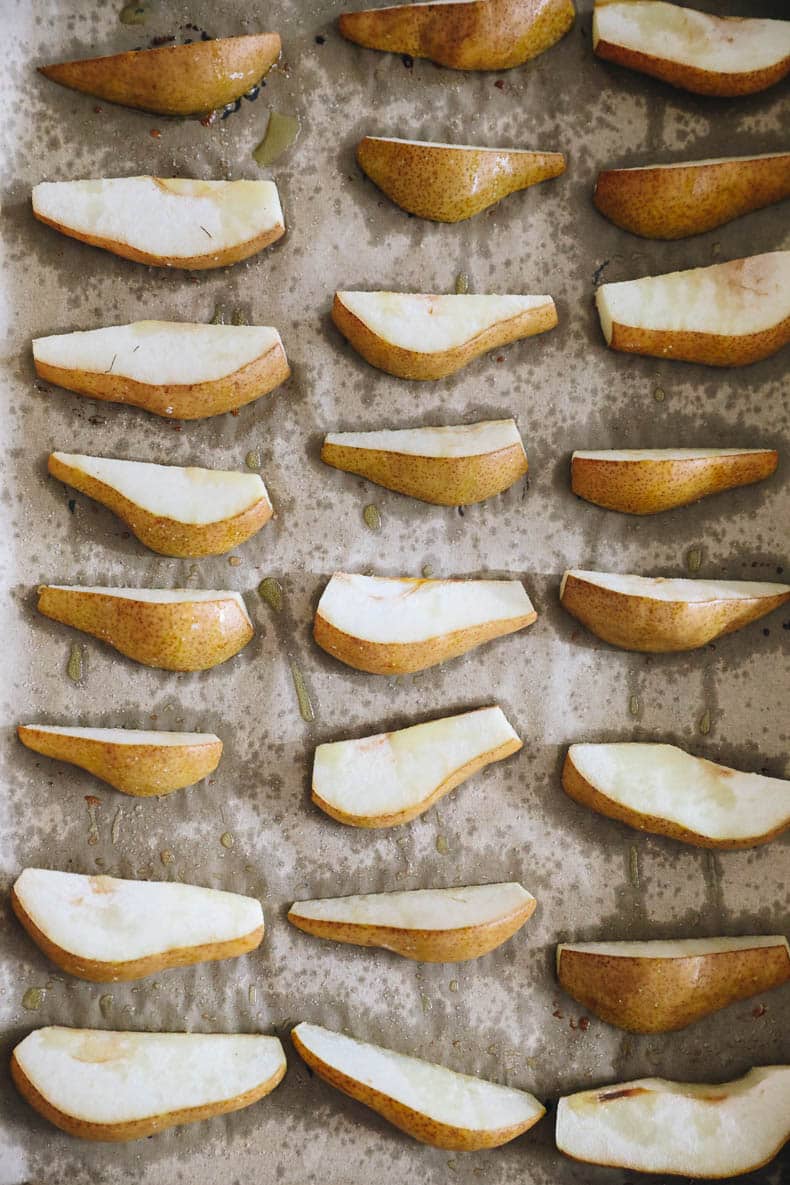 Roasted pears on a parchment-lined baking sheet