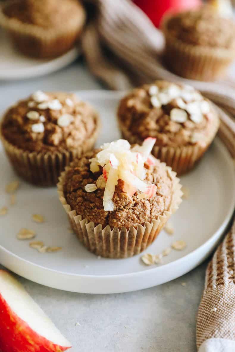 Baked oatmeal apple muffins with shredded apple on top.