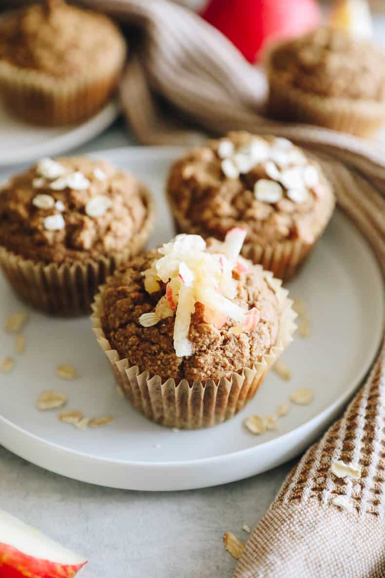up close image of an applesauce muffin with shredded apple on top.