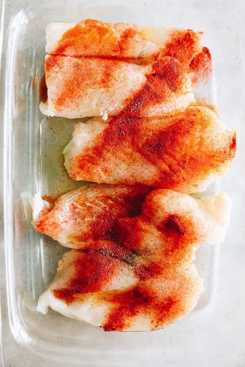 marinated cod in a glass dish.