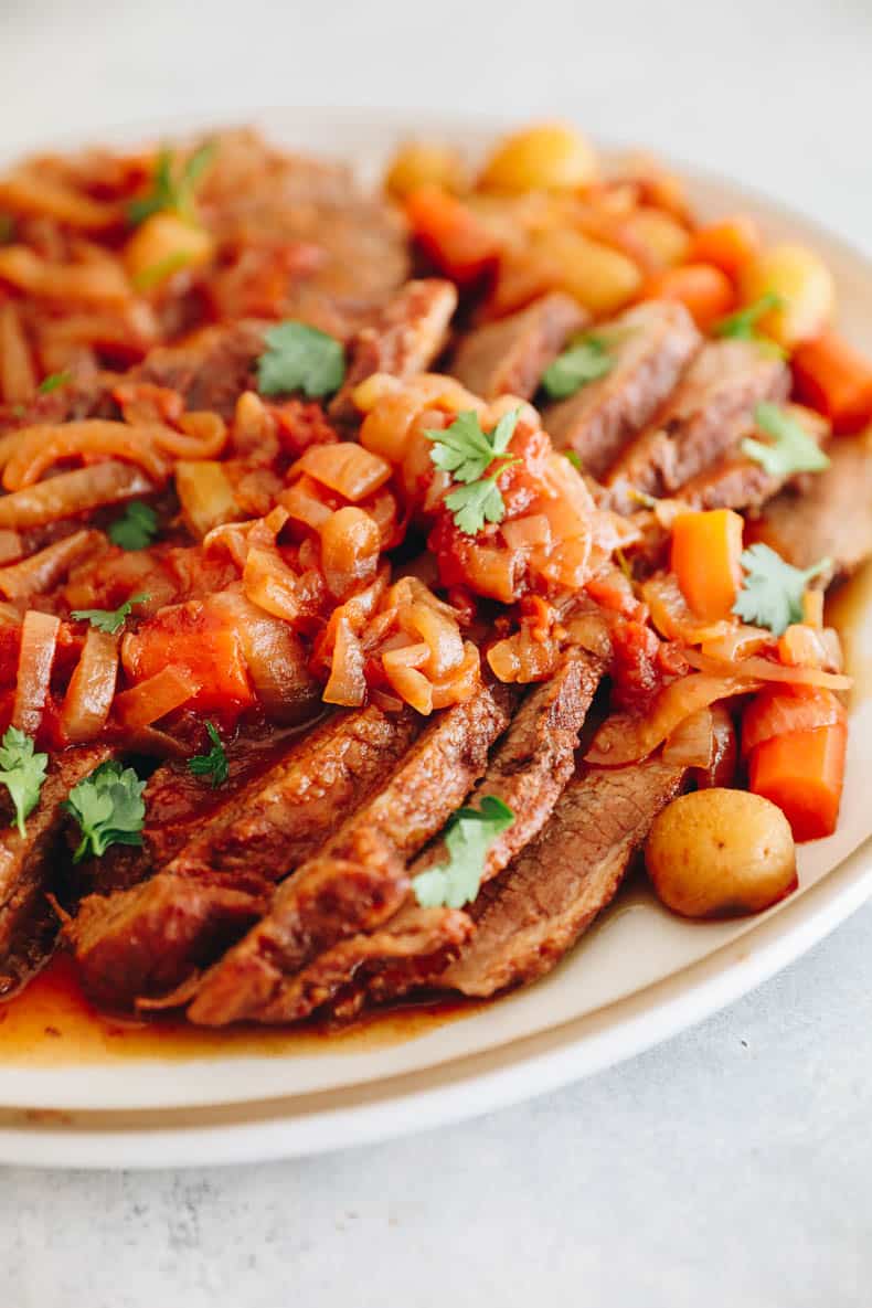 oven roasted brisket with caramelized onions, potatoes and carrots.