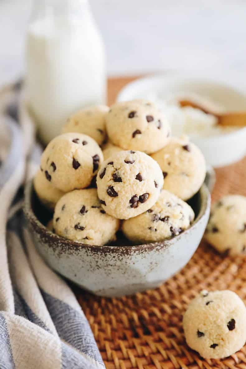 Cookie dough protein balls in a blue bowl.