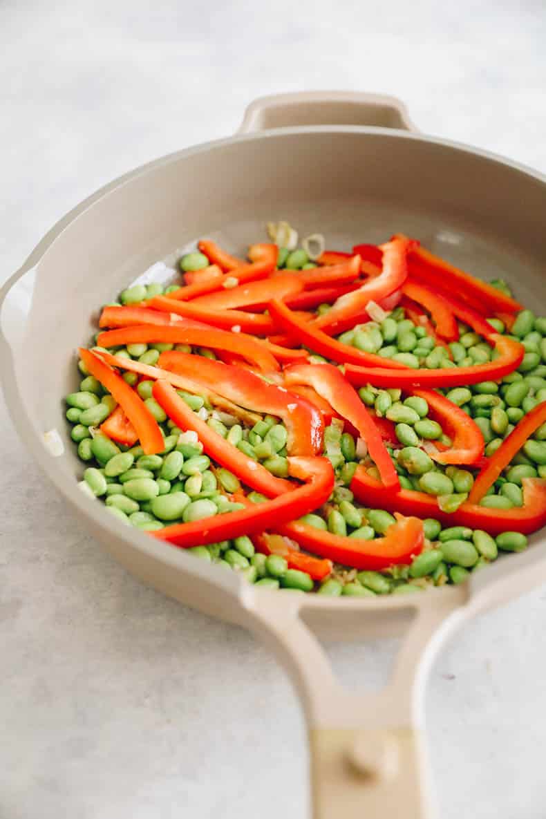bell pepper and edamame in a pan.
