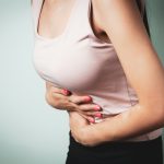 A person holding their stomach in pain